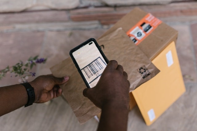 Delivery driver scanning a package label to confirm delivery